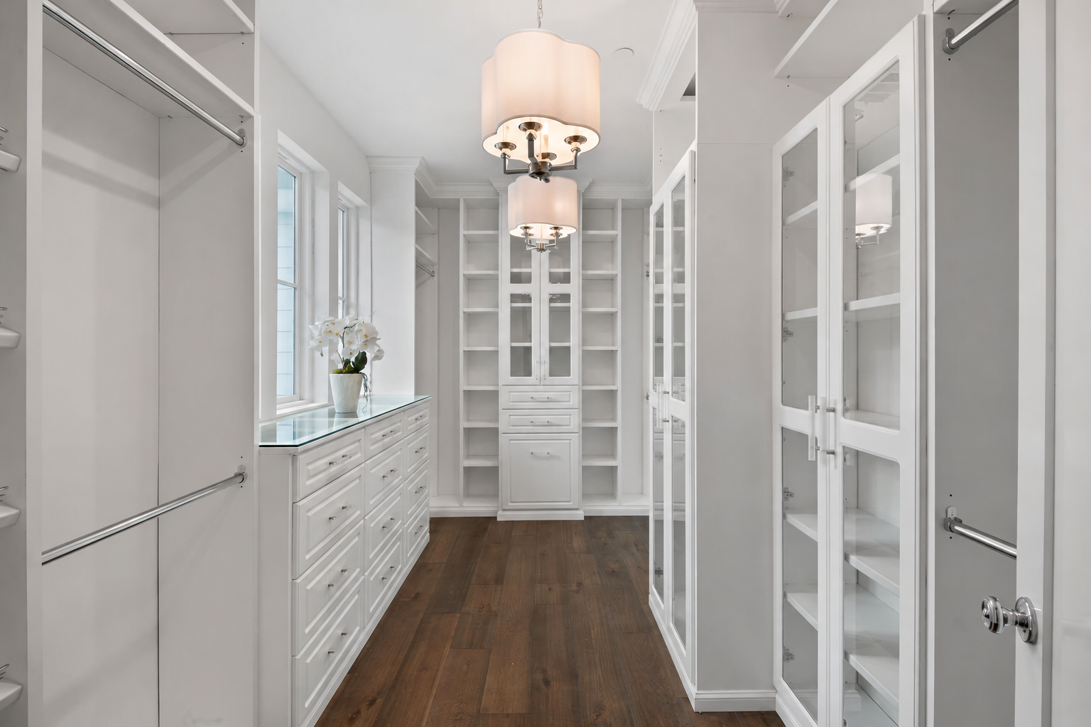 Elegant white walk-in closet with chandeliers
